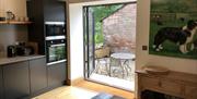 Double doors from the kitchen to the patio at The Barn at Linden Farm House in Langwathby, Cumbria