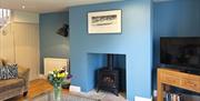 Wood burner and living area at The Cottage at Linden Farm House in Langwathby, Cumbria