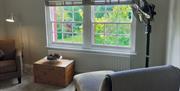 Lounge chair with garden view at The Cottage at Linden Farm House in Langwathby, Cumbria