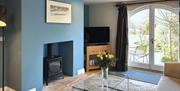 Wood burner and living area at The Cottage at Linden Farm House in Langwathby, Cumbria