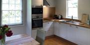 Kitchen and dining table at The Cottage at Linden Farm House in Langwathby, Cumbria