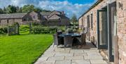 Exterior and patio seating at Low Ploughlands Holiday Lets in Little Musgrave, Cumbria