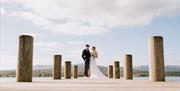 Bridal Couple on a Jetty at Low Wood Bay Resort & Spa in Windermere, Lake District