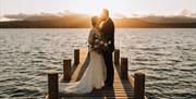 Bridal Couple on a Jetty at Low Wood Bay Resort & Spa in Windermere, Lake District