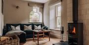 Living room with wood burner in the House at Meadow Brow Estate in Grasmere, Lake District