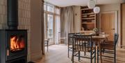 Dining area and wood burner in the House at Meadow Brow Estate in Grasmere, Lake District