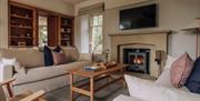 Living area with wood burner in the House at Meadow Brow Estate in Grasmere, Lake District