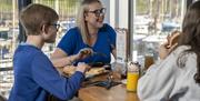 Family having food & drink at Marina View Cafe in Maryport, Cumbria