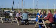 Visitors sitting outside at Marina View Cafe in Maryport, Cumbria