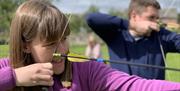 Visitors Practicing Archery with Michael Coates Clay Shooting in the Lake District, Cumbria