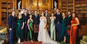 Bride and Groom Posing with Family at Muncaster Castle in Ravenglass, Lake District