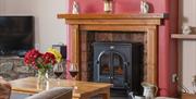 Wood burner and living space in Stable Barn at Near Howe Cottages in the Lake District, Cumbria