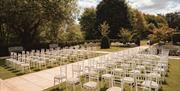 Seating arranged on the grounds for an outdoor wedding at Abbey House Hotel & Gardens in Barrow-in-Furness, Cumbria