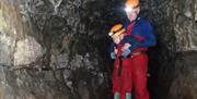 Family Exploring a Mine with Go Cave in the Lake District and Cumbria