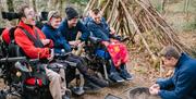 Visitors in wheelchairs learning outdoor skills with Lake District Calvert Trust