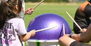 Children drumming at an event held by BarrowFull in Barrow-in-Furness, Cumbria