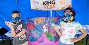 Children making spray paint artwork at an event held by BarrowFull in Barrow-in-Furness, Cumbria