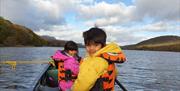 Visitors on a Guided Canoe Trip with Path to Adventure in Coniston, Lake District