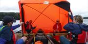 Visitors on a Guided Canoe Trip with Path to Adventure in Coniston, Lake District