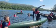 Visitors on a Guided Canoe Trip with Path to Adventure in Coniston, Lake District