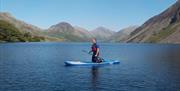 Visitor Paddleboarding in the Lake District with Path to Adventure