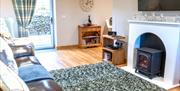 Living area and wood burner at Patton Hall Farm Country Cottages near Kendal, Cumbria