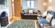 Living room with wood burner at Patton Hall Farm Country Cottages near Kendal, Cumbria