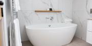 Freestanding tub in a bathroom at Pentonbridge Inn in Penton, Cumbria