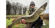 Customer posing with a fish caught with a Rigged and Ready fishing rod