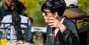 Visitor Enjoying Outdoor Drinks and Dining at Brewery Arts Centre in Kendal, Cumbria