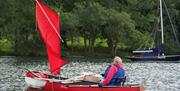 canoe sailing. lady using a supportive seat and stabilisers to prevent cap size