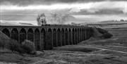 Historic Black-and-White Photo of a Steam Train on The Settle - Carlisle Railway line in Cumbria, UK