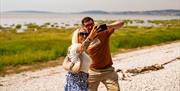 Couple take selfies by the sea at Holgates Holiday Park in Silverdale, Cumbria
