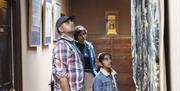 Visitors Admiring artwork in the house at Sizergh Castle, Lake District - National Trust