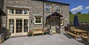 Entrance and Patio Seating at Spring Cottage at Helm Mount Lodge & Cottages in Barrows Green, Cumbria
