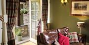 Door from Living Area to Patio Seating at Spring Cottage at Helm Mount Lodge & Cottages in Barrows Green, Cumbria