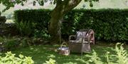 Outside Seating under a Tree in the Garden at Stone Cottage in Patterdale, Lake District