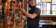 Staff Pouring Beer at Ambleside Tap Yard in Ambleside, Lake District
