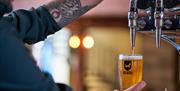 Staff Pouring a Beer at Ambleside Tap Yard in Ambleside, Lake District