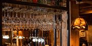 Wine glasses at the bar at The Ambleside Inn in Ambleside, Lake District