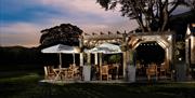Outdoor seating at dusk at The Coniston Inn, Coniston, Lake District