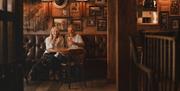 Couple having drinks at The Coniston Inn, Coniston, Lake District
