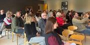 People seated theatre-style at The Hub at The Heaning Estate in Windermere, Lake District