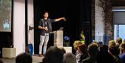 Presenter on Stage in a Function Space in The Pencil Factory in Keswick, Lake District