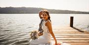 Bridal Couple posing for portraits at a Wedding at The Ro Hotel in Bowness-on-Windermere, Lake District