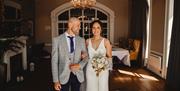 Bridal Couple posing for portraits at a Wedding at The Ro Hotel in Bowness-on-Windermere, Lake District