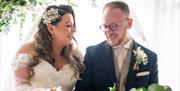 Bridal Couple posing for portraits at a Wedding at The Ro Hotel in Bowness-on-Windermere, Lake District
