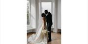 Bridal Couple posing for portraits at a Wedding at The Ro Hotel in Bowness-on-Windermere, Lake District