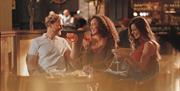 Visitors enjoying drinks at The Ullswater Inn in Glenridding, Lake District