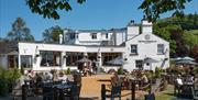 Visitors using outdoor seating at The Wateredge Inn in Ambleside, Lake District